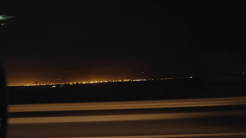 Driving down a street at night