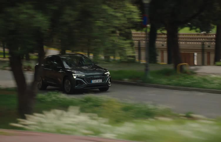 The cars drive past the building