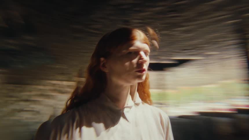Redhaired woman with the suns reflection on her face