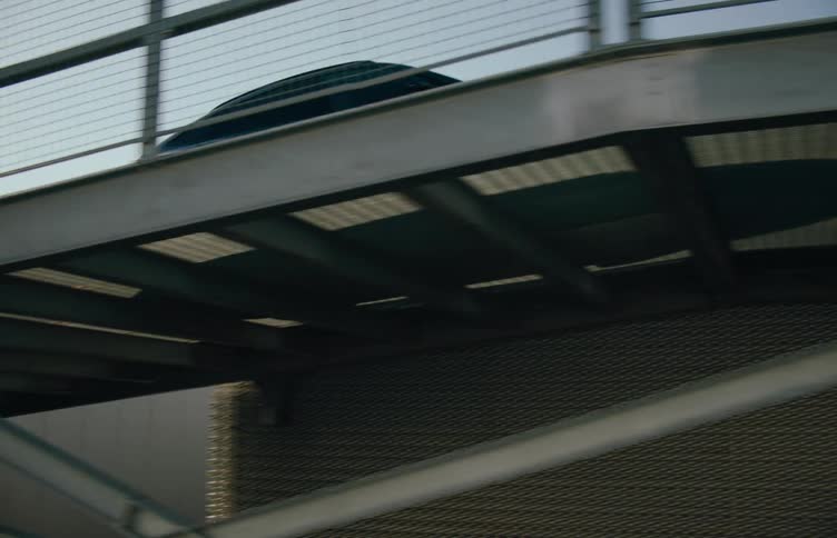 A car moving on the metal bridge during the day