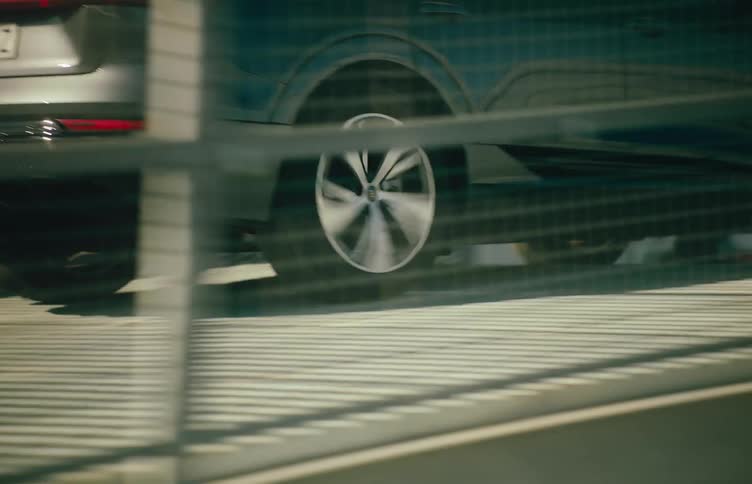 A sleek audi electric suv drives along a sunlit modern bridge