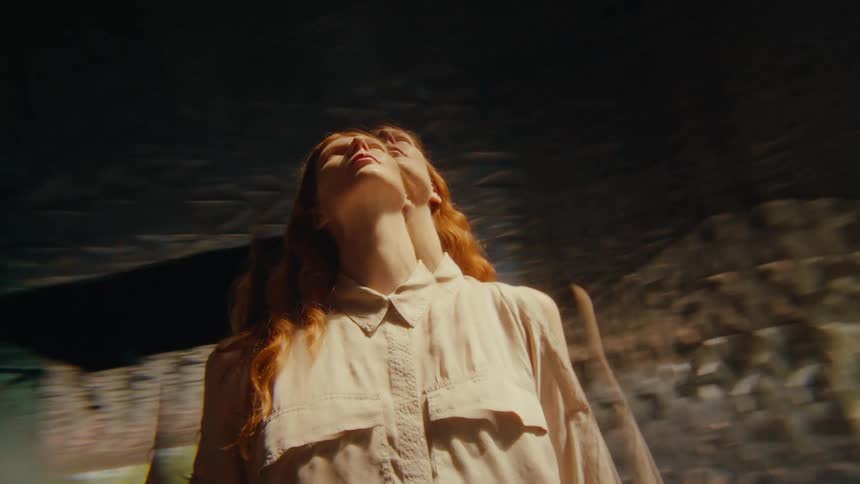 A woman is looking over the building