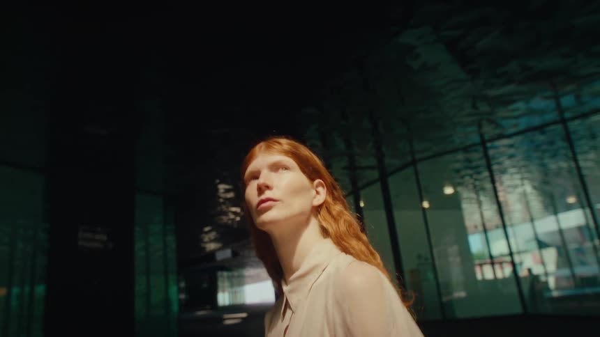 A woman is walking in the city during the day