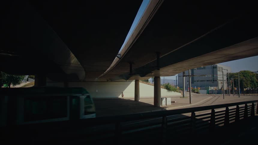 The train travels under the overpass