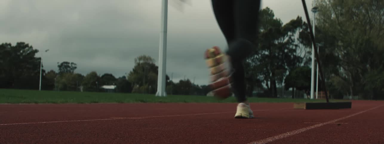 A woman runs on the track to pole vault
