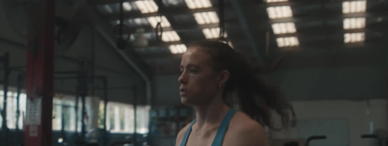 A young caucasian woman skips as a form of exercise in a fitness room