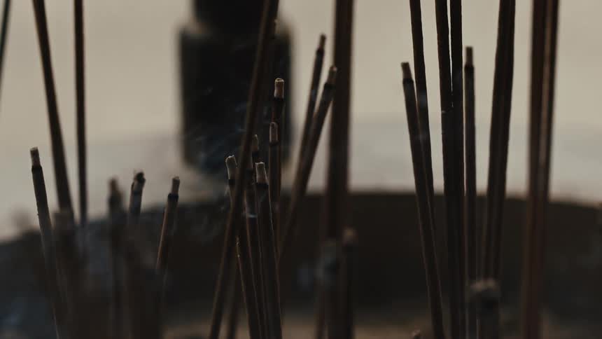 The incense is burning and giving off smoke
