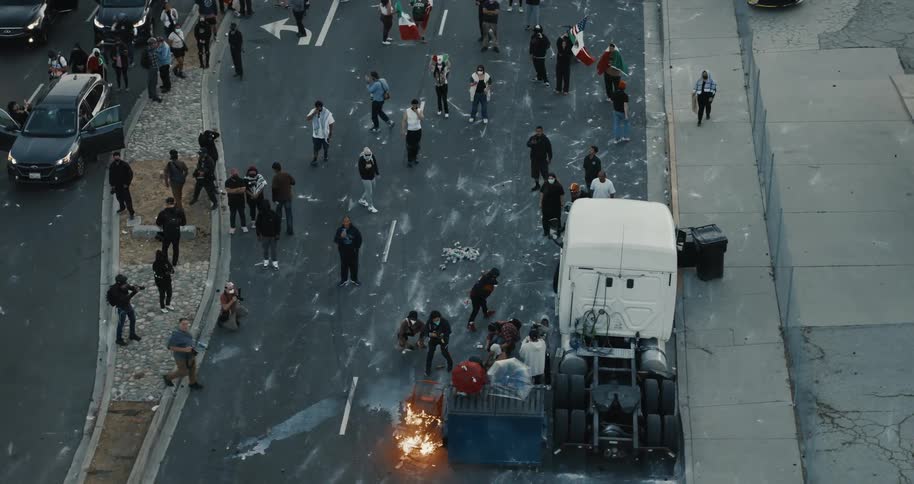 A group of people helps an accident victim on a truck by the side of the road in the city at midday