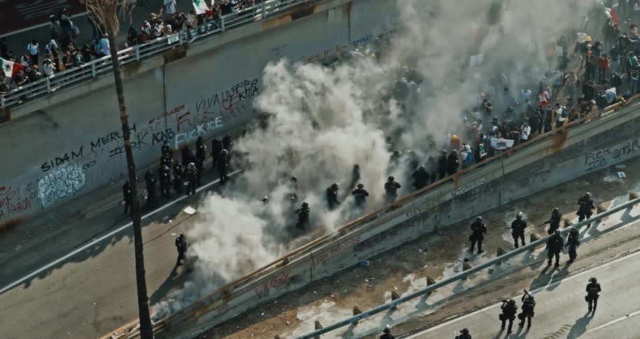 People fight amid police and smoke