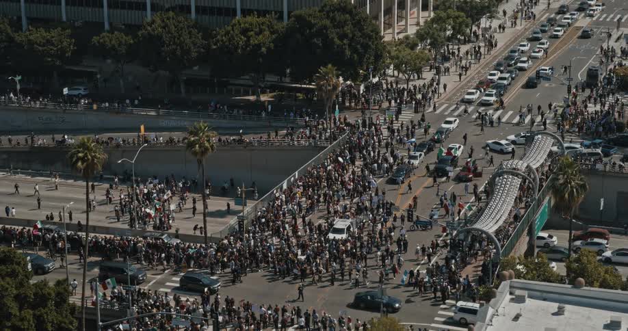 A massive crowd fills multiple city streets during a largescale urban protest
