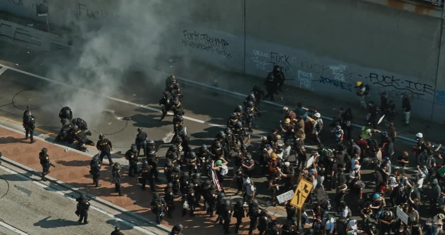 Riot police face off against protesters on a smoky city street