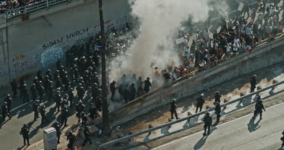 CHP and police officers deploy tear gas against protestors on a freeway onramp in Downtown Los Angeles