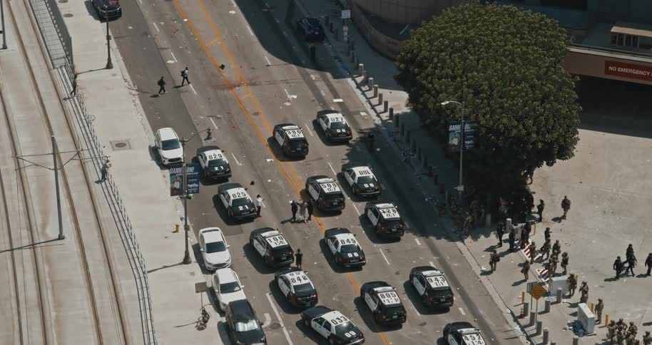 Aerial view of a police operation on an urban road during the day