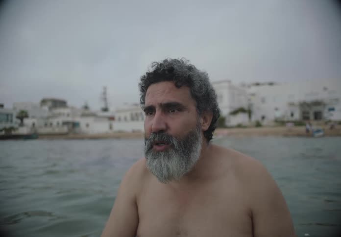 A man is talking while standing in the water