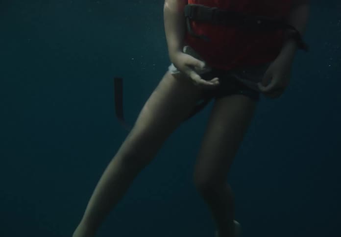 A boy is floating in the water with a life jacket