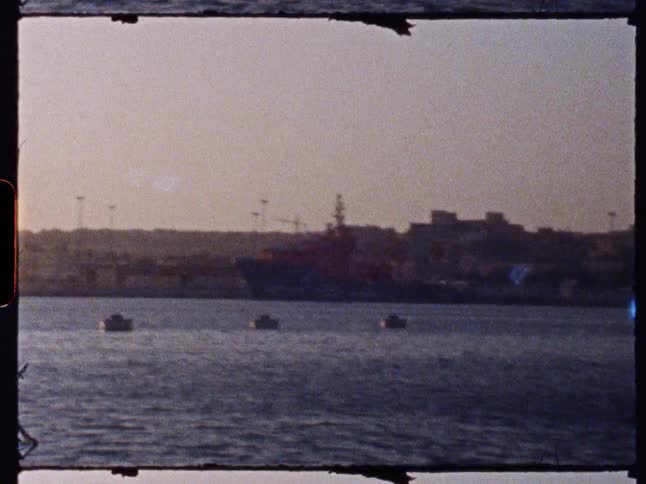 A large ship is docked at the harbor