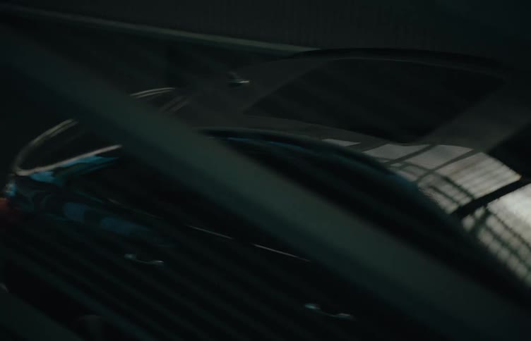 Black car passing by a metal surface