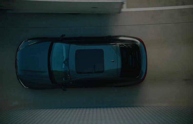 The car drives through the outdoor parking garage