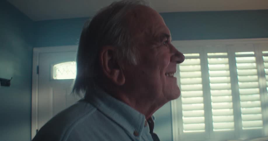 Elderly man is dancing by himself inside of his house