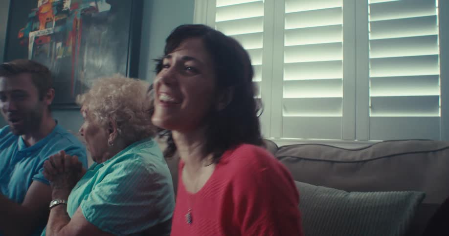 People are cheering and laughing at the television