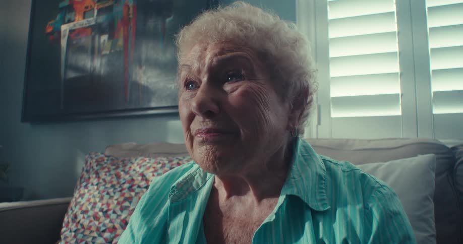 A woman on the couch speaks briefly