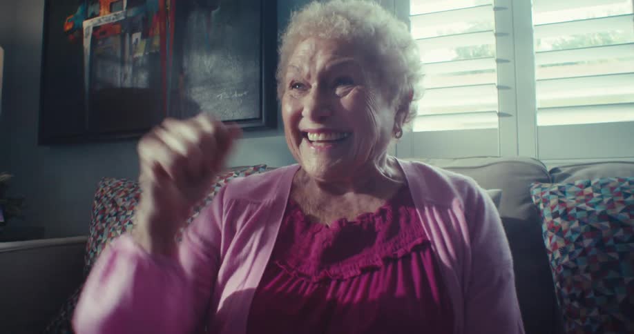 A woman pumps her fist while smiling