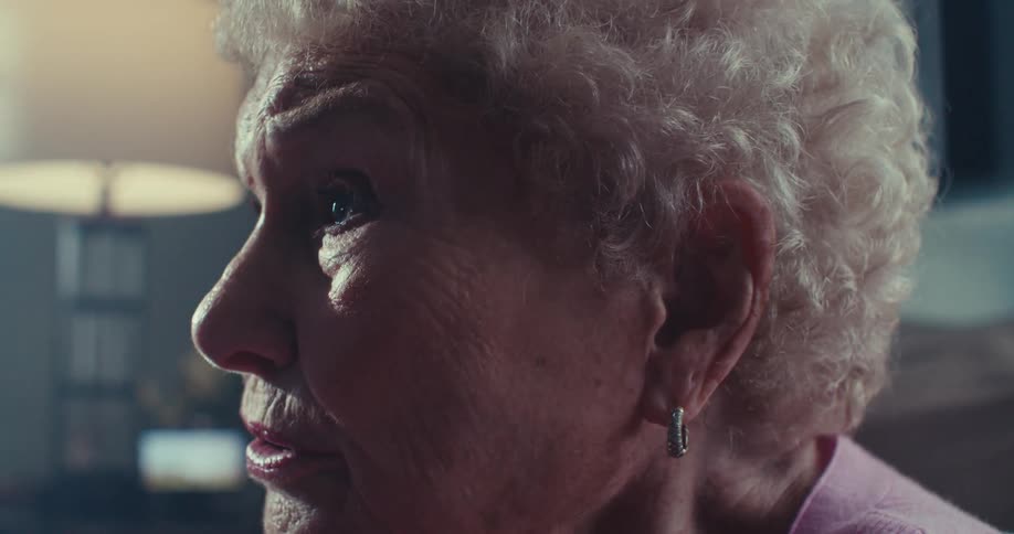 Side portrait of an elderly woman talking