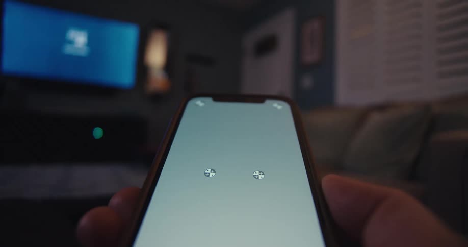 Looking at the phone while sitting in the living room