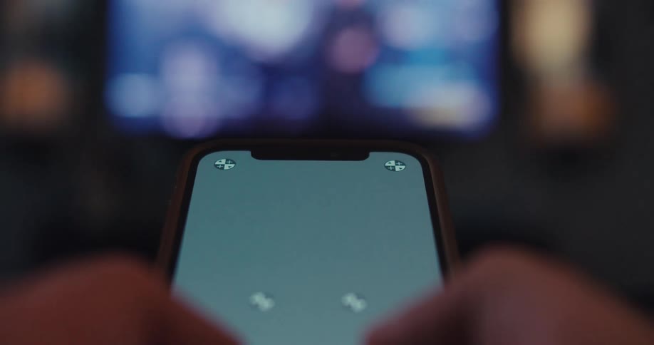 Close up of a phone operated by a person sitting in a living room