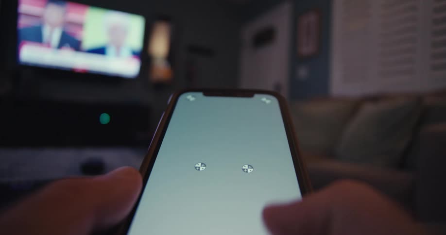 Close up of a person swiping the screen while using a mobile in a living room
