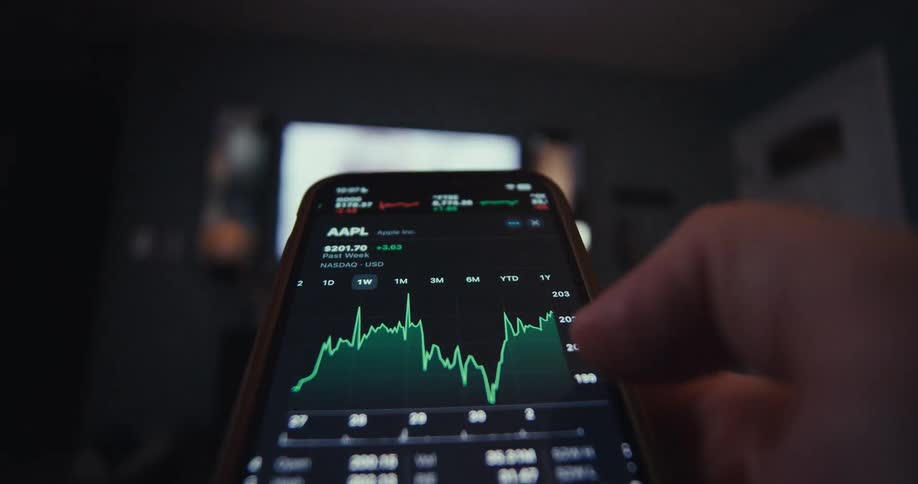 Hand using stock exchange app on a smartphone