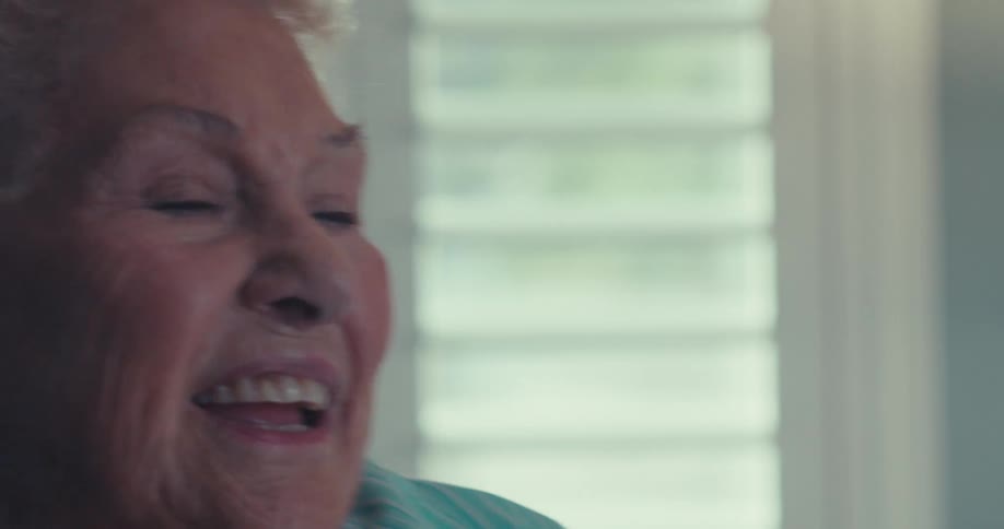 Elderly woman is dancing alone inside of her home