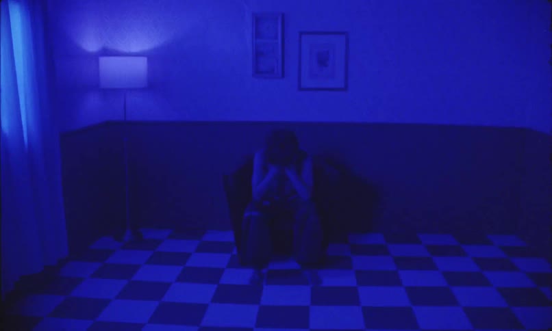 A man is sitting in the dark room