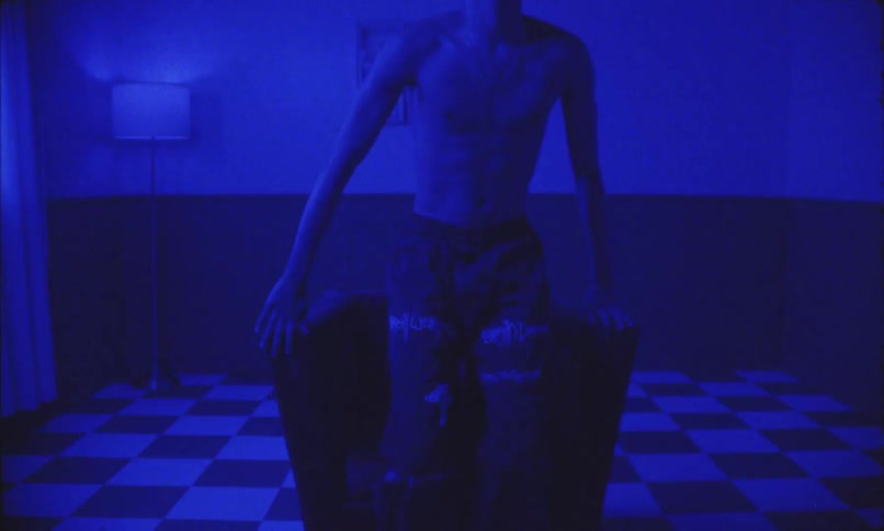 Boy getting up from an armchair in a room