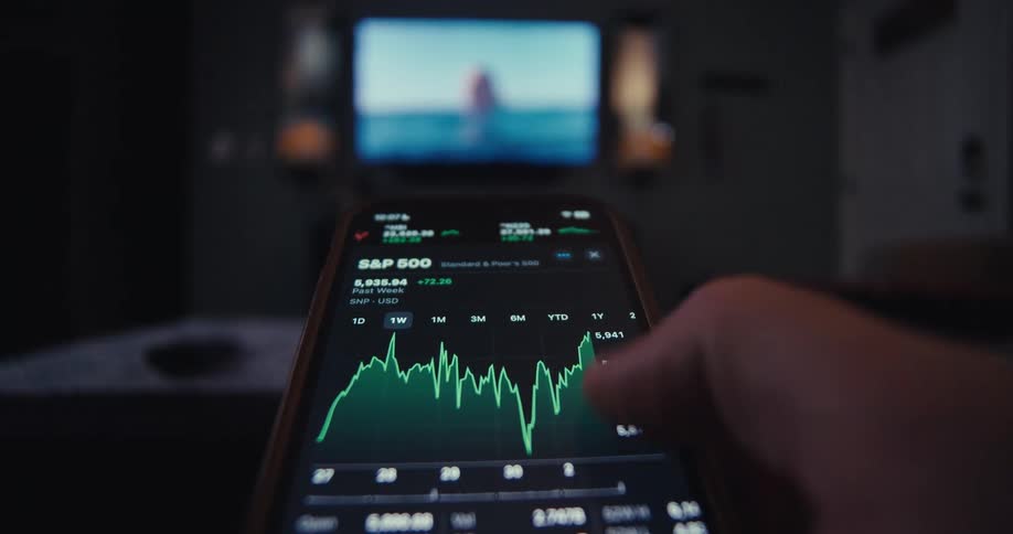 Hand interacting with smartphone in a stock exchange app