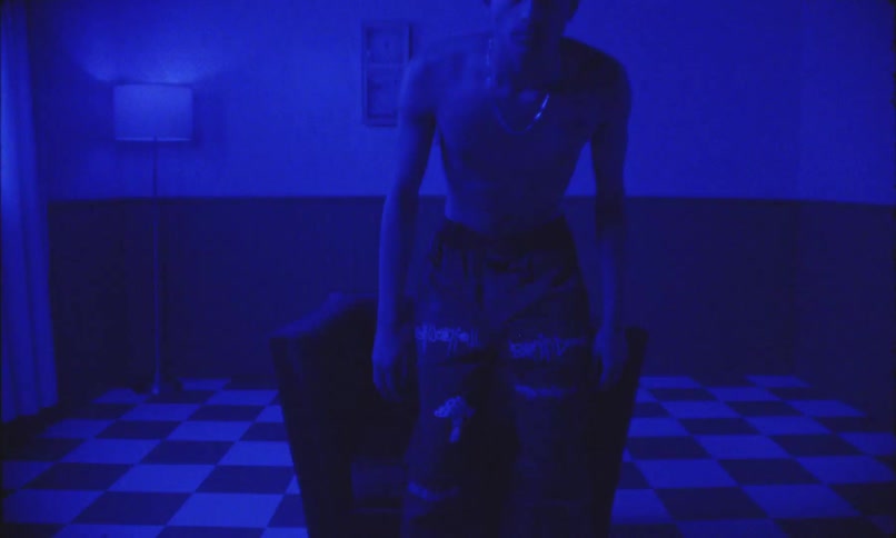 The man sits down on the chair in the dark room