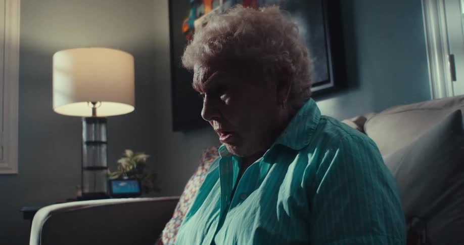 A woman is concerned while talking with someone on her tablet