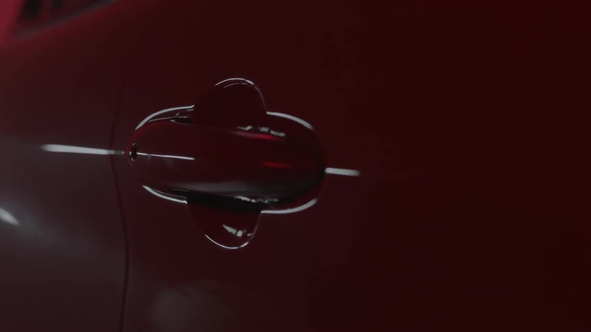 Light reflects off a red car door