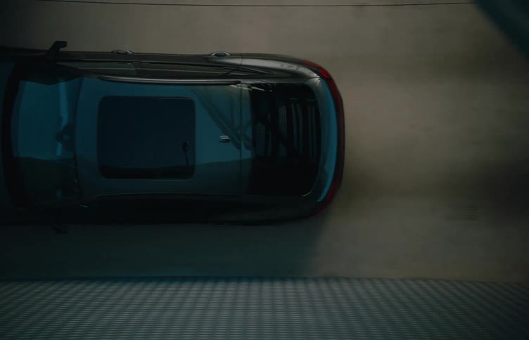 The car drives through the multi leveled parking garage