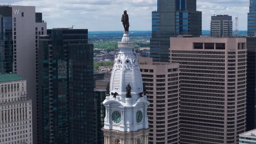 Aerial of Philadelphia City Hall and William Penn statue  in a metropolis on a partly cloudy summer day