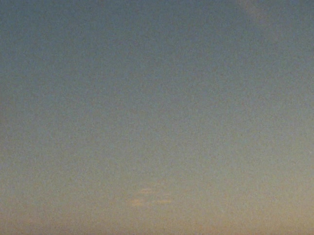 The sun is rising on the shore