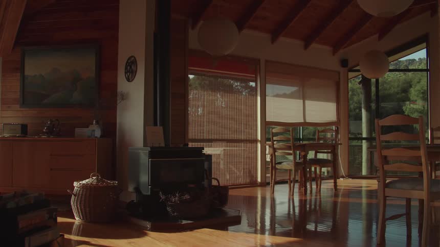 Sun shines into a home standing in the hills during the daytime