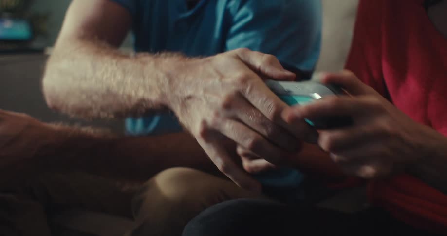 A man tries to grab a womans controller as they play video games