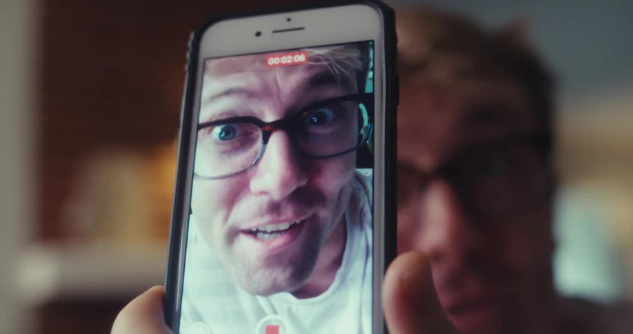 A man records himself on his phone