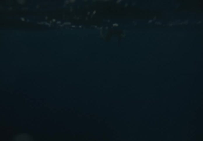 A boy is out floating in the deep waters
