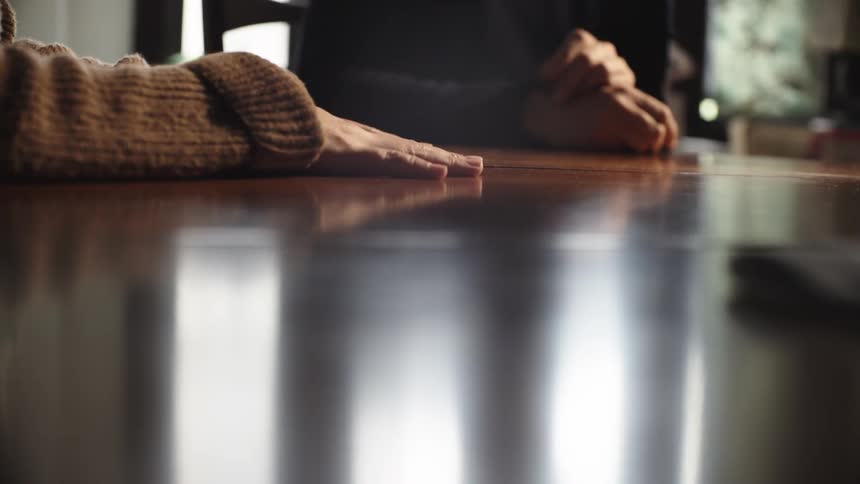 Two people are moving their hands while having a conversation