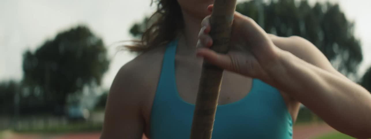 A woman prepares to pole vault on the track