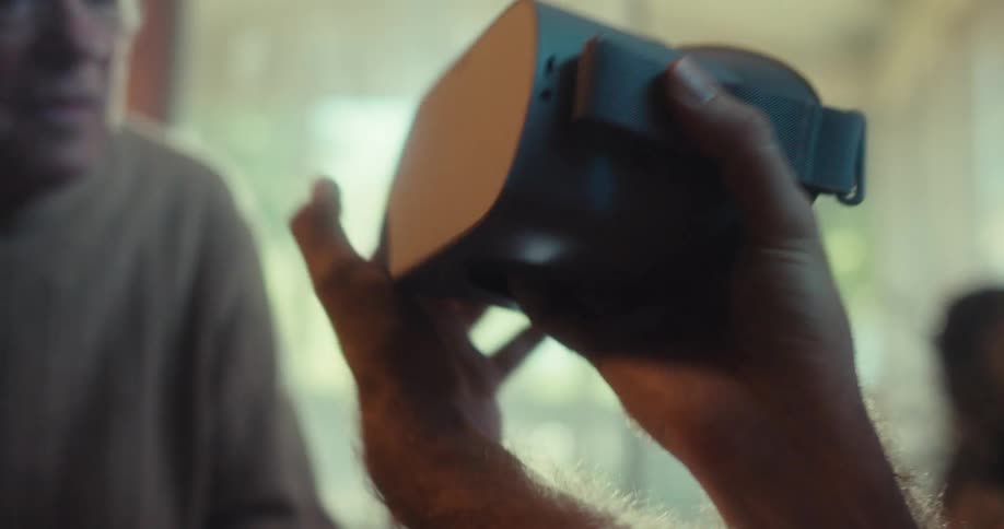 Pair of hands handling virtual reality glasses
