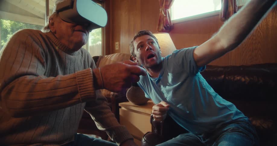 Young man giving instructions to an elderly man using virtual reality glasses