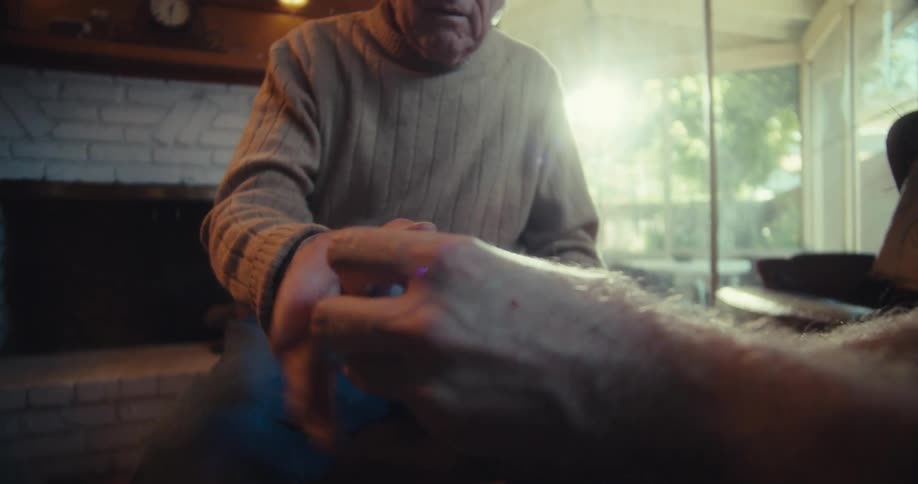 String being tied around an elderly mans wrist
